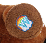 Close-up of a brown plush toy with a colorful embroidered Webkinz logo on a white background