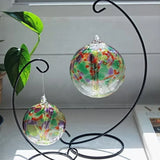 Close-up of Tree of Life hand-blown glass ornament showing colourful glass leaves